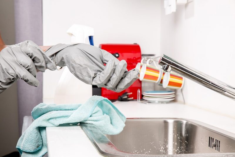 A person in gloves is holding onto some medicine.