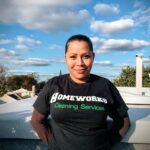 A woman standing on top of a roof.